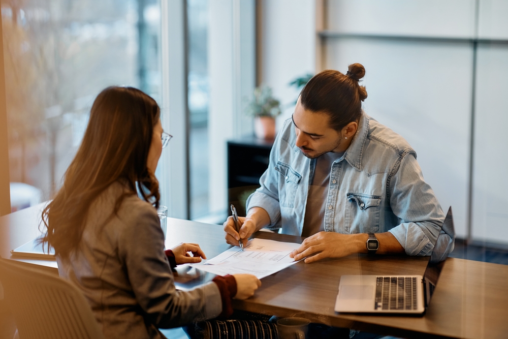 Hispanic,Man,Signing,A,Contract,While,Having,Meeting,With,Financial employment contracts