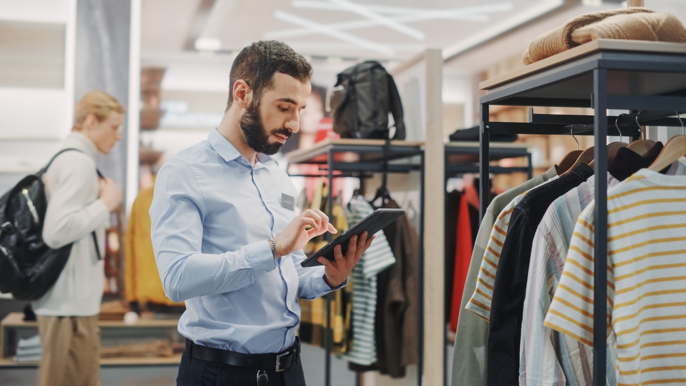 Clothing,Store:,Male,Visual,Merchandising,Professional,Uses,Tablet,Computer,To retail and hr