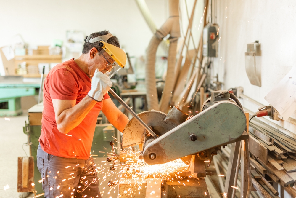 Adult,Man,Working,With,An,Iron,Cutter,,Sparks,Flying manufacturing and HR