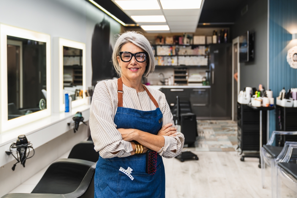 Senior,Woman,Entrepreneur,Standing,With,Arms,Crossed,,Smiling,Inside,Her HR and Hairdresser