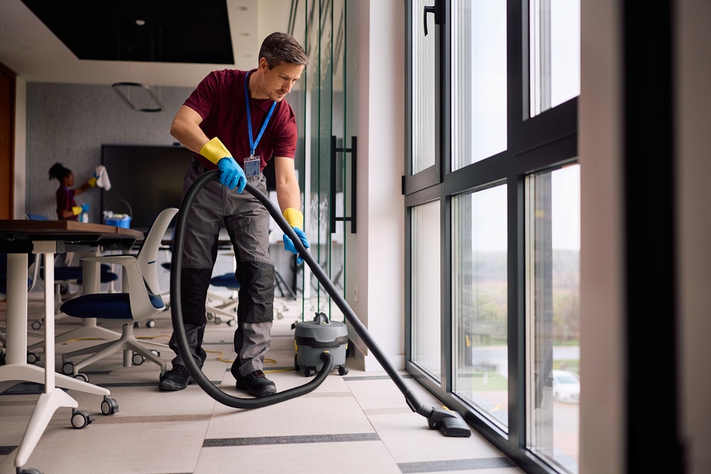 Janitorial,Service,Employee,Using,Vacuum,Cleaner,While,Working,In,The commercial cleaning