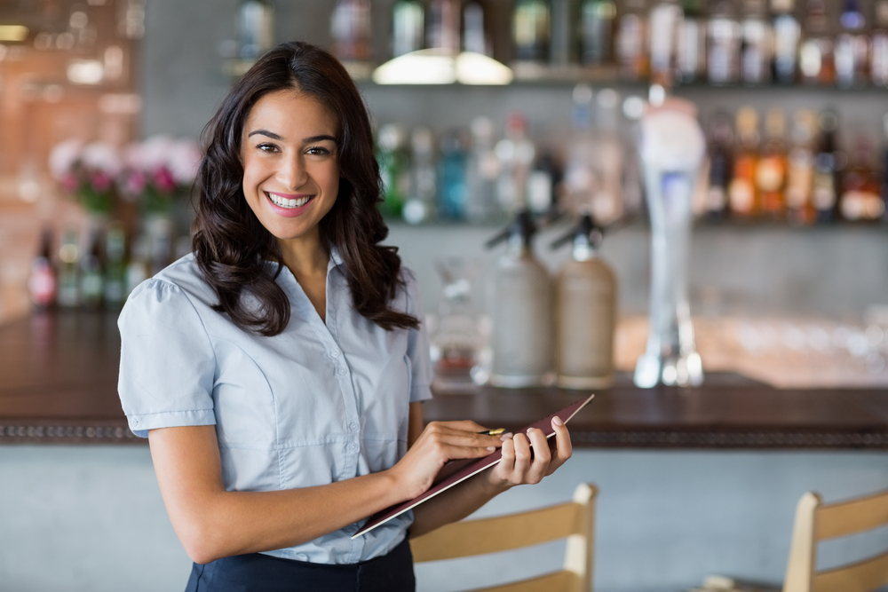 Portrait,Of,Smiling,Waitress,Holding,A,File,In,Restaurant hospitality and hr